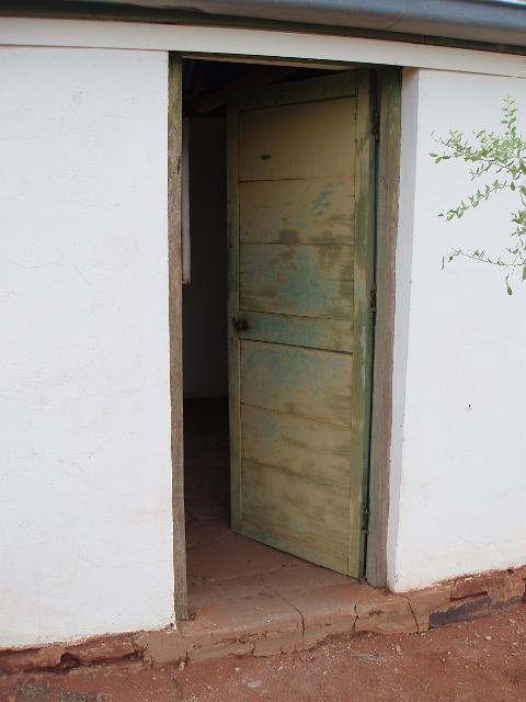 entrance to a small abandoned historic house