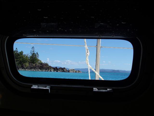 the view from a porthole on a cruising sailing yacht in the whitsundays