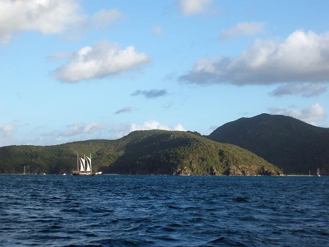 a three masted sailing ship with sails a loft passing the north end of hook island, whitsundays