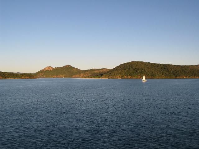 a lone sailing boat exploring the whitsunday islands