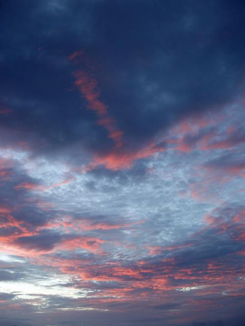 a background image featuring a pink sunset, taken over the town of airle beach, queensland