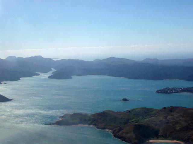 an aerial view of the whitsundays islands, dent island in the foreground, whitsunday behind, queensland