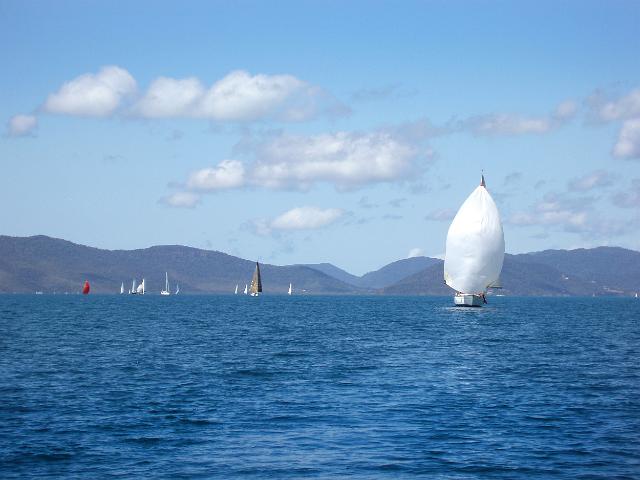 boats sailing downwind flying spinnaker sails duiring airlie beach race week