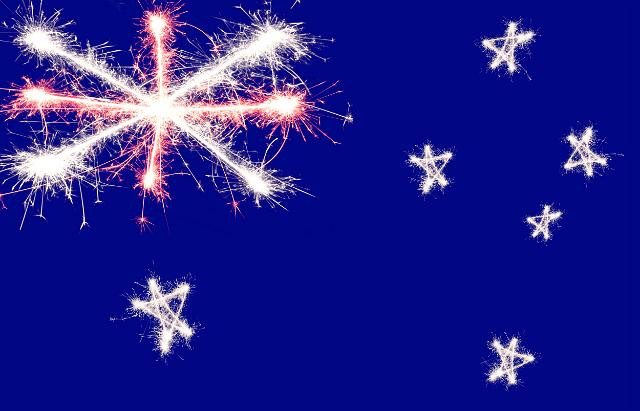 the shape of the australian flag drawn in coloured sparking light