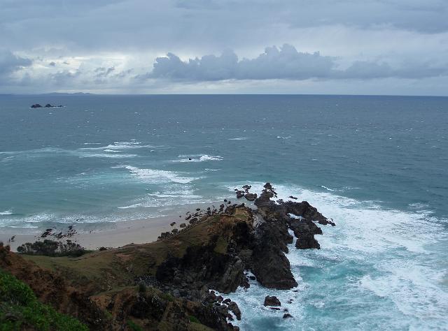 looking down at rocks at the bottom of the cliffs of cape byron, mainland australias eastern most point