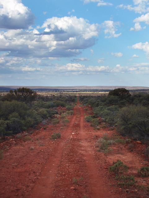 a long desert track stretches onto the horizon