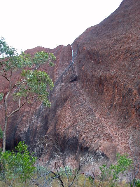 a rare sight - a tricke of water running off uluru after a passing shower