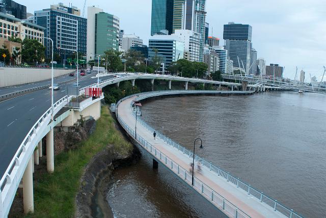 Waterfront view of central Brisbane and Coronation Drive with the Kurilpa Bridge curving around the bank of the Brisbane River