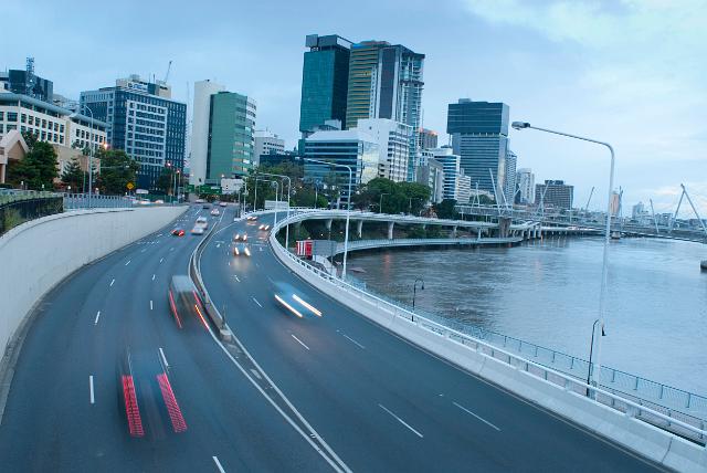 Traffic on Coronation Drive, Brisbane driving along the bank of the Brisbane River with the highrise buildings of the CBD in the background