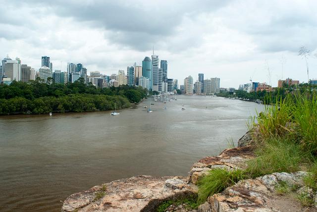 View looking up the Brisbane River, Queensland, Australia with the city on the skyline under a cloudy sky