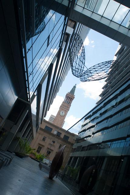 Brisbane City Hall Clock Tower, a historical landmark in the city centre viewed between two modern high rise buildings