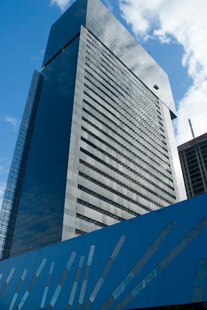 Brisbane Square, australia with a low angle view of a modern highrise commercial building against the skyline