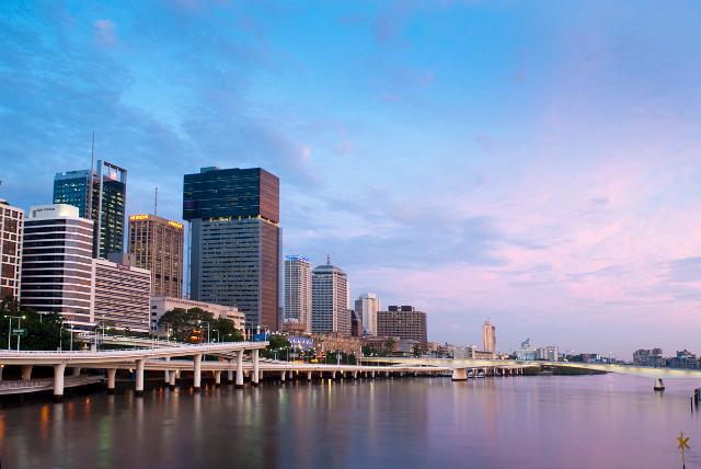 a pretty view of the brisbane river, victoria bridge and office buildings in central bisrbane at sunset