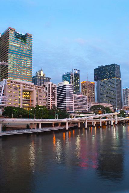 Central Brisbane, Australia at dusk with the colourful lights from the commercial highrise buildings in the CBD reflected in the water of the Brisbane River