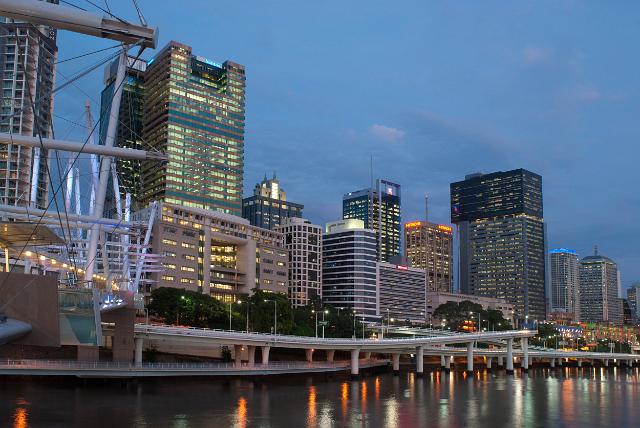 Central Brisbane at twilight with the colourful lights from the highrise buildings in the CBD reflected in the water of the Brisbane River