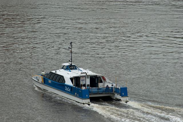 City Cat Ferry plowing the water of the Brisbane River transporting commuters and tourists, high angle view
