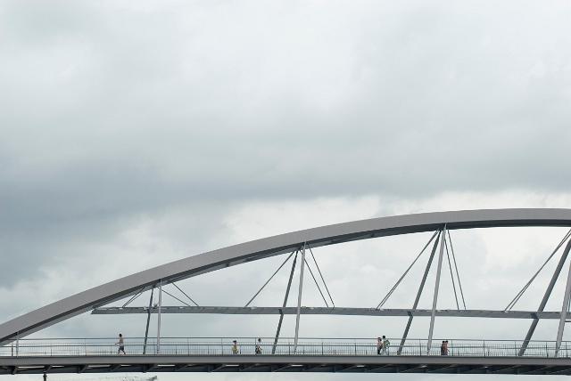 Goodwill Bridge in Brisbane is a heritage-listed landmark over the Brisbane River with a distinctive steel arch seen here against a cloudy sky