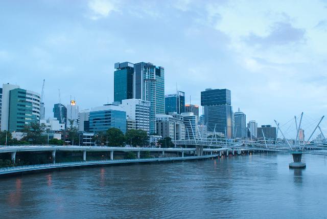 Central Brisbane on a cloudy day with a view across the Brisbane River of the waterfront of the CBD and the Kurilpa Bridge