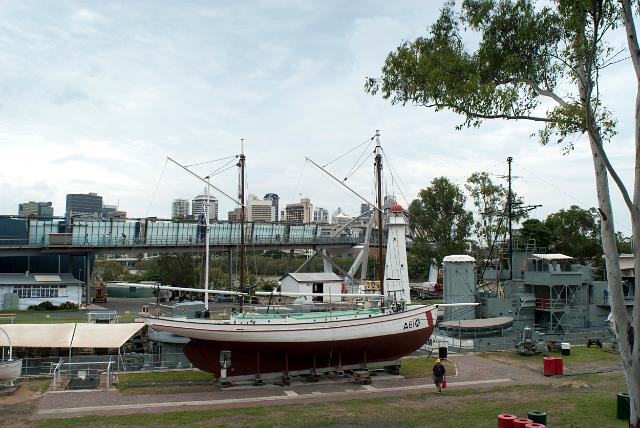 View of the exterior displays of the Brisbane Maritime Museum with a historical vintage wooden tall ship raised on a wharf for public access