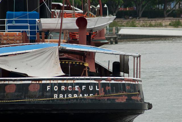 Old rusty tugboat called the Forceful registered in Brisbane, Queensland, Australia moored in the docks showing the name on the hull