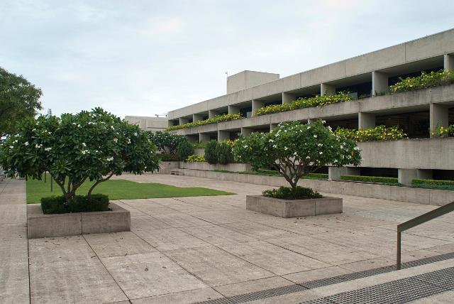 View of the forecourt and front facade of the Queensland Art Gallery, Brisbane with its balconies decorated with flowering plants
