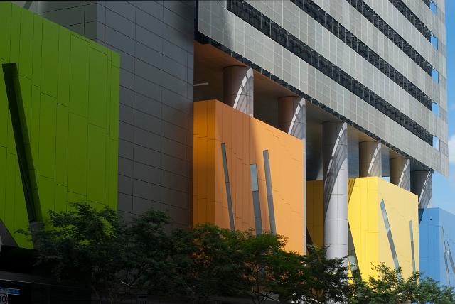 Colourful modern architecture in Brisbane Square with multicoloured decorative panels at the foot of a commercial office block