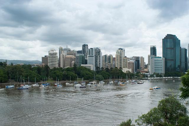 Cityscape of Brisbane from Kangaroo Point looking across the Brisbane River with pleasure boats moored along the river bank