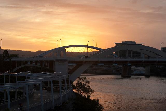 Evening view at sunset of the William Jolly Bridge which is a heritage listed bridge over the Brisbane River with a steel arch in Brisbane, Queensland, Australia