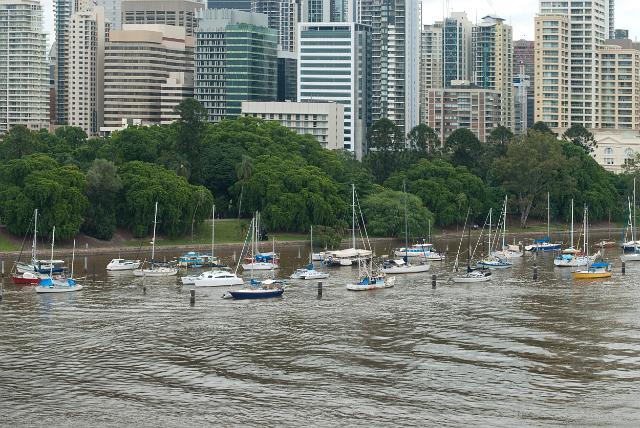 Brisbane from Kangaroo Point with a view of yachts and pleasure craft moored in the river against a backdrop of the modern highrise buildings in the CBD district