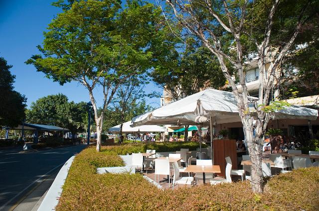 Airlie Esplanade open-air restaurants with outdoors seating under umbrellas in Airlie Beach, Queensland, Australia