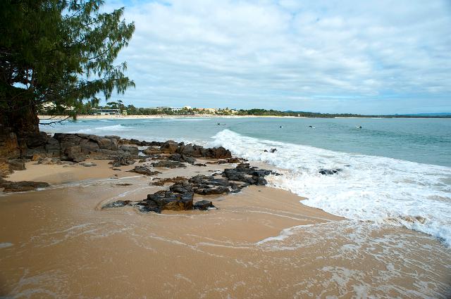Rocky shoreline with golden sand at Noosa beach in Queensland, Australia, a popular tourist resort and destination for surfers