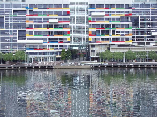colourful modern buildings reflected on the water of melbournes docklands development
