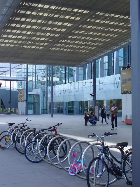a row of bicycles outside melbourne museum